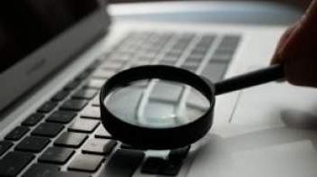 Magnifying glass over computer keyboard